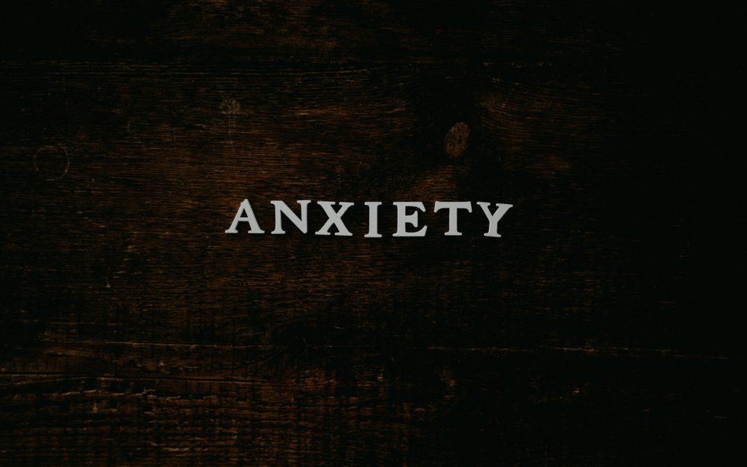letters spelling out the word anxiety on a wooden background