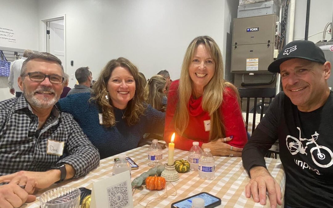 Gina with friends at a friendsgiving dinner.